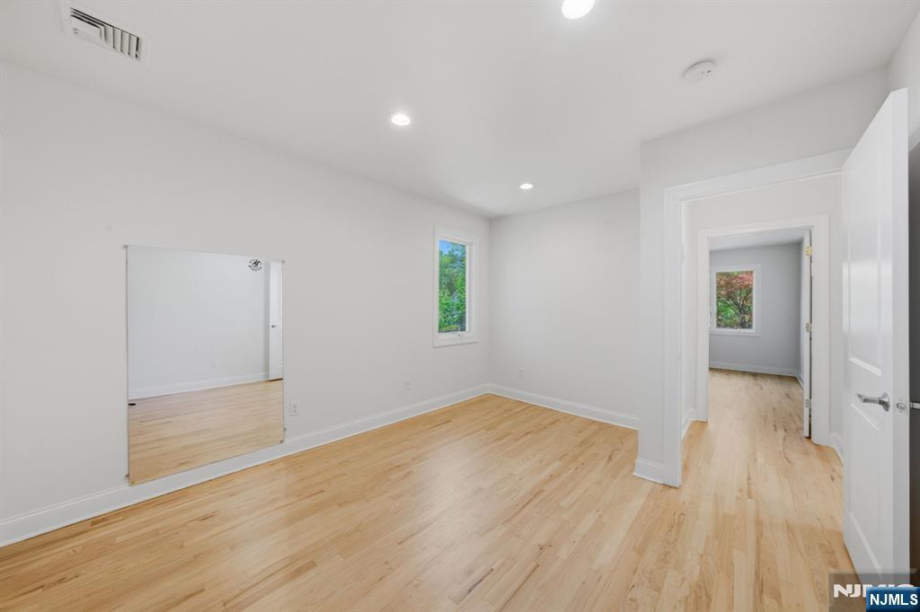 232 Riveredge Road Tenafly, NJ 07670 - Photo 22 of 50 wooden floor in an empty room with a window