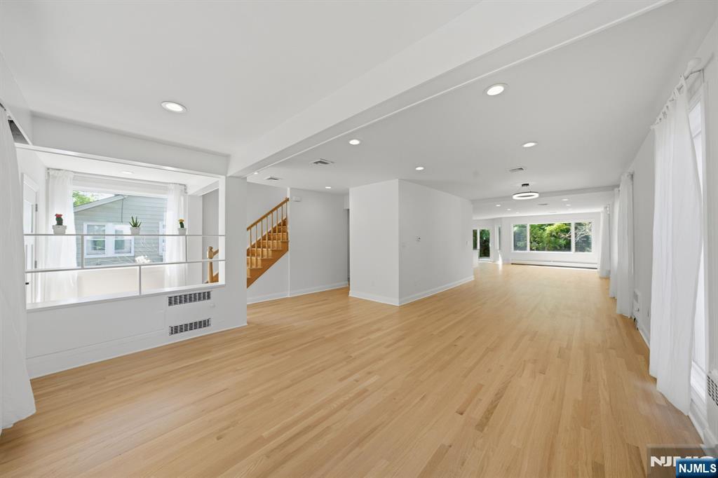 232 Riveredge Road Tenafly, NJ 07670 - Photo 8 of 50 a view of an empty room with a window and wooden floor