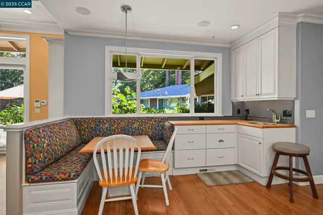 a view of patio with table and chairs and potted plants