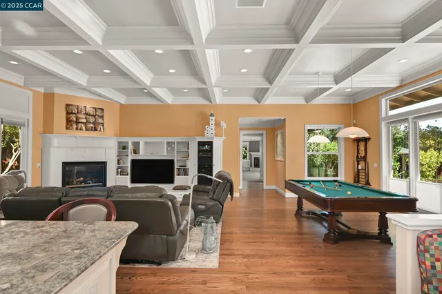 a dining room with furniture and a floor to ceiling window