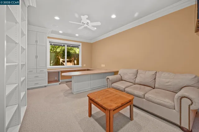 a view of a patio with table and chairs under an umbrella with a fire pit