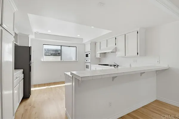 a kitchen with stainless steel appliances a sink stove and refrigerator