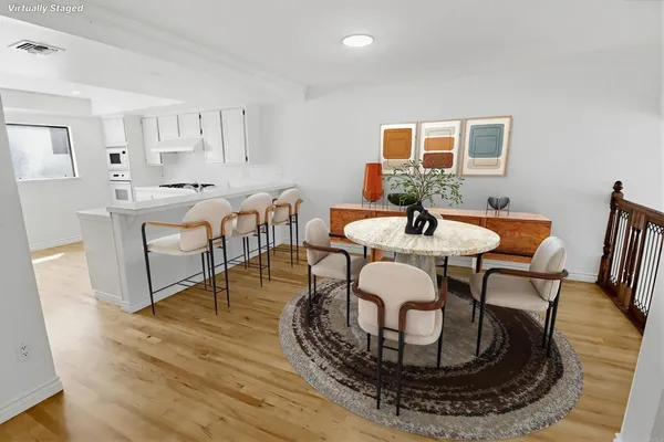 a view of a dining room with furniture and wooden floor