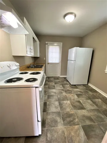 a utility room with cabinets washer and dryer