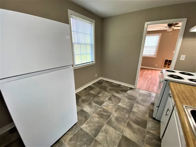 a view of a kitchen from a hallway