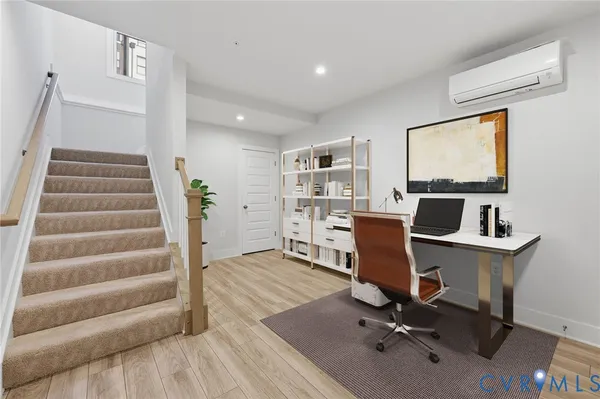 a view of a workspace with furniture and lounge chair