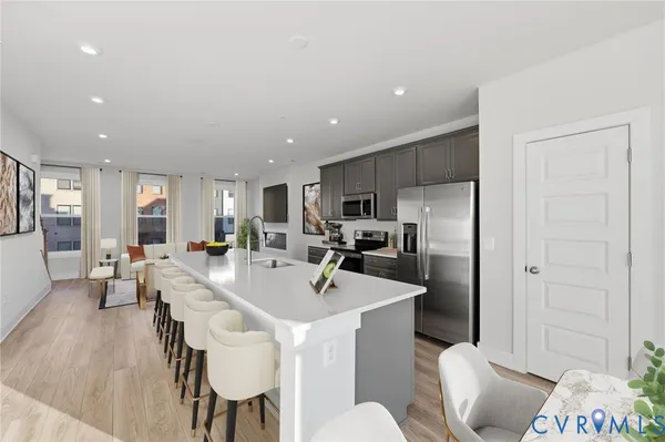 a large kitchen with a table and chairs