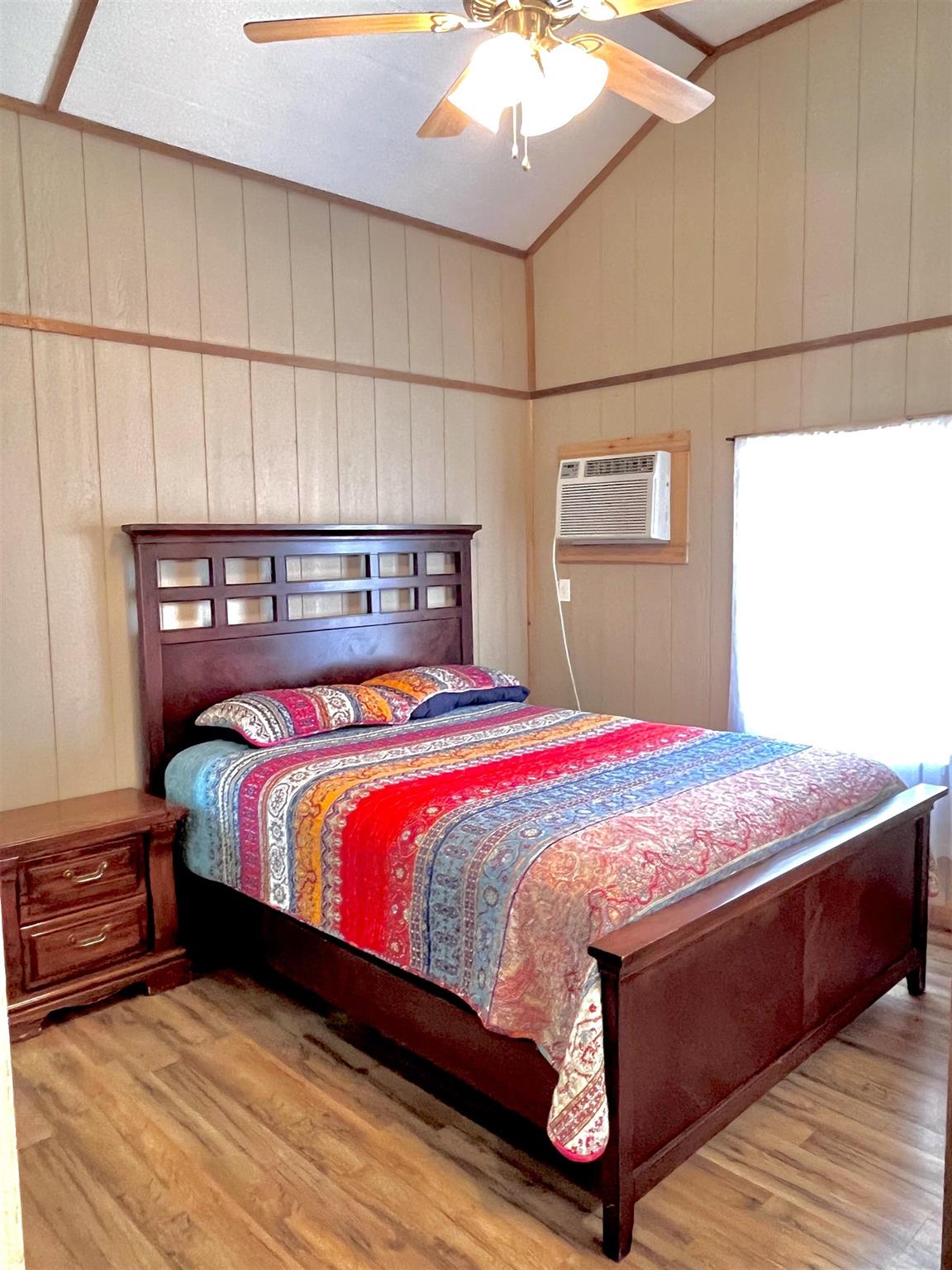 175 Elmer Road Llano, TX 78643 - Photo 12 of 25 a bedroom with a bed and a night stand