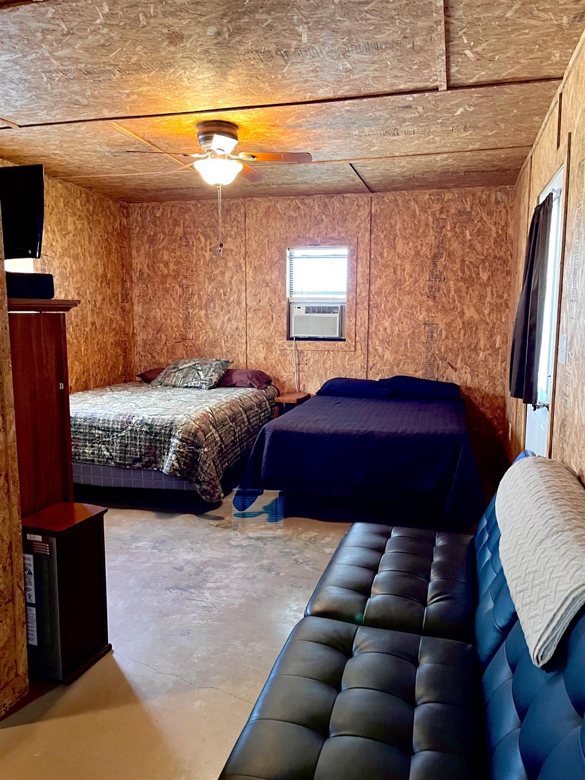 175 Elmer Road Llano, TX 78643 - Photo 20 of 25 a bedroom with a bed window and a couch