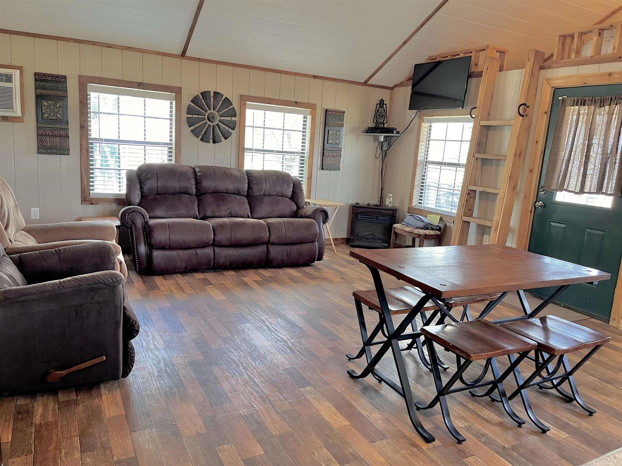 175 Elmer Road Llano, TX 78643 - Photo 8 of 25 a living room with furniture a wooden floor and a window