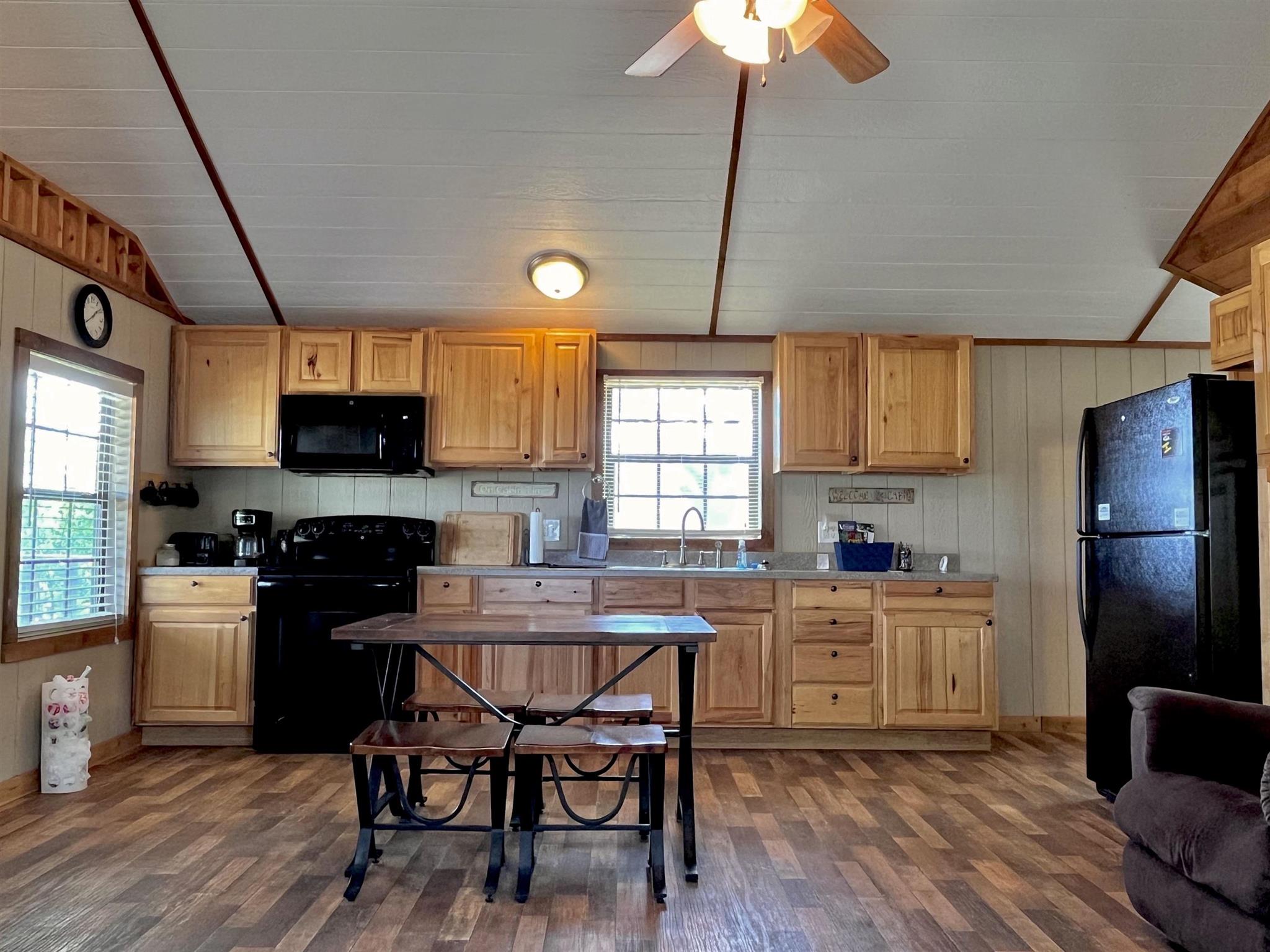 175 Elmer Road Llano, TX 78643 - Photo 10 of 25 a kitchen with a table chairs refrigerator and cabinets