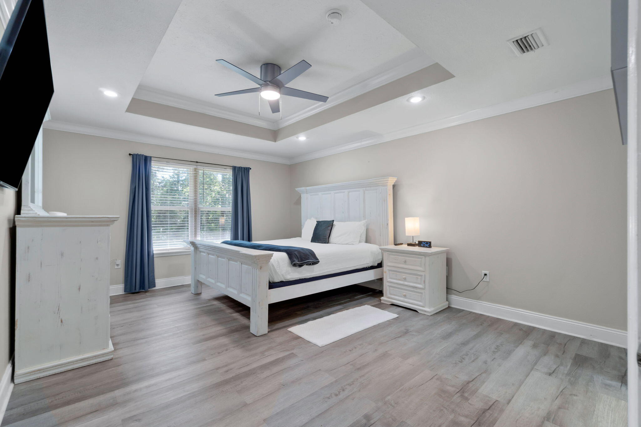 6983 Snug Waters Road Navarre, FL 32566 - Photo 33 of 48 a spacious bedroom with a bed and a large window