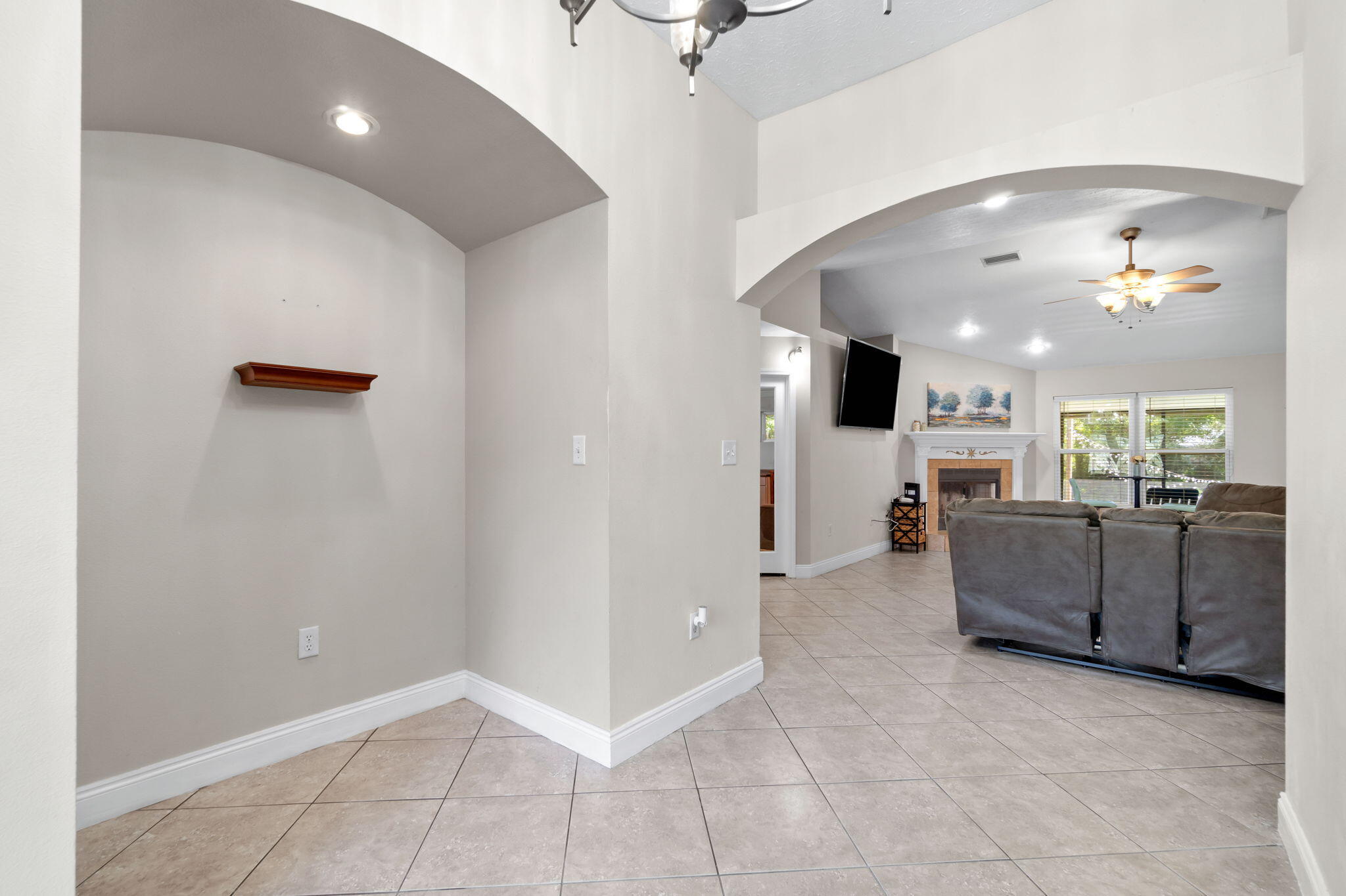 6983 Snug Waters Road Navarre, FL 32566 - Photo 6 of 48 a view of a livingroom with furniture and a ceiling fan