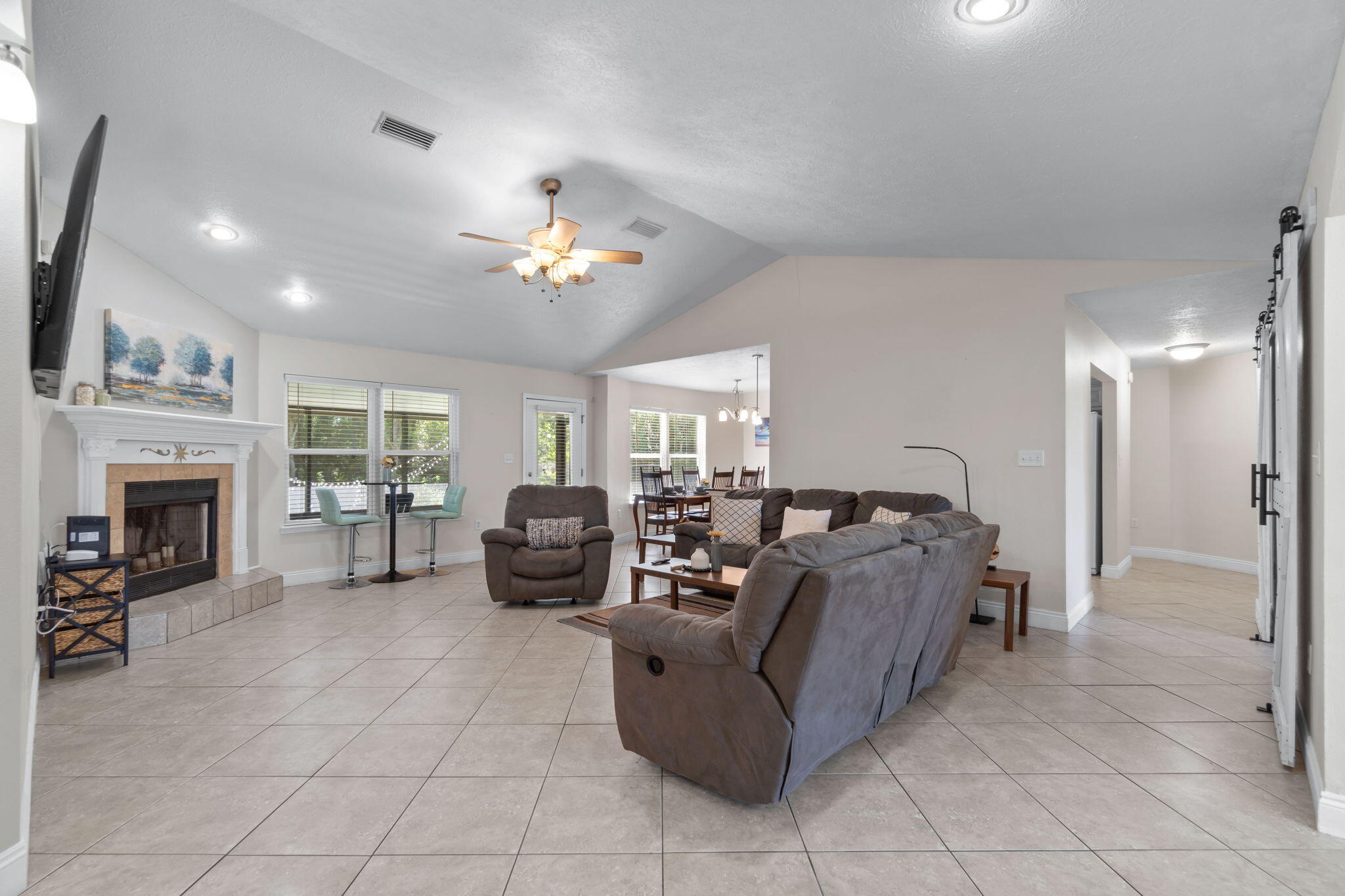 6983 Snug Waters Road Navarre, FL 32566 - Photo 8 of 48 a living room with furniture and a fireplace