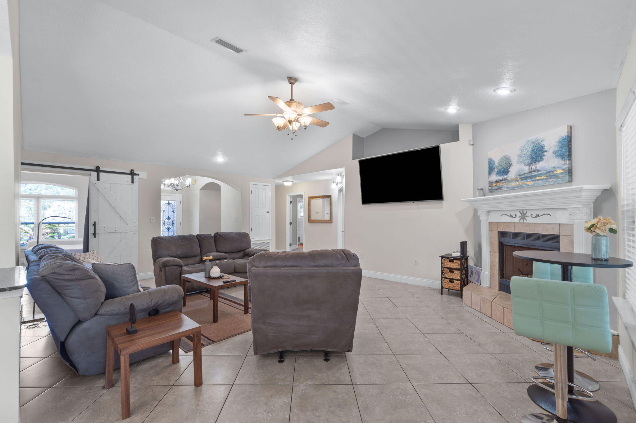 6983 Snug Waters Road Navarre, FL 32566 - Photo 10 of 48 a living room with furniture a fireplace and a flat screen tv