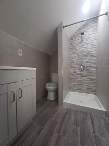 a bathroom with a toilet and a shower