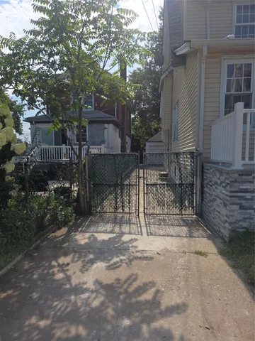a view of a bench with wooden fence