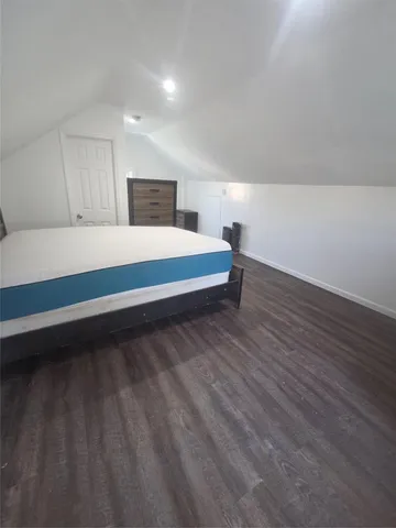 a bedroom with a bed and a night stand