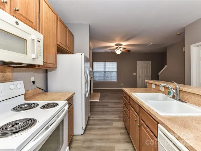a kitchen with a stove a sink and a refrigerator