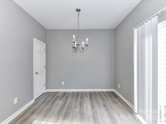 a view of a room with wooden floor and window