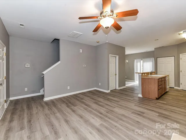 a view of a kitchen with a sink and a chandelier fan