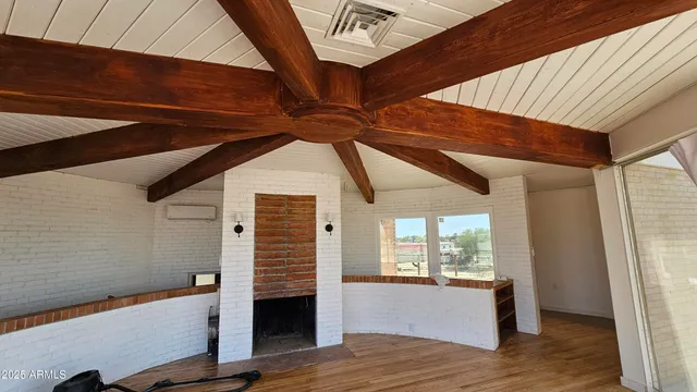 a view of room with window and wooden floor