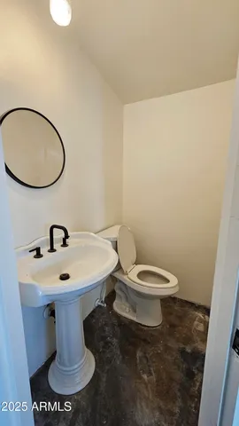 a white toilet sitting next to a bathroom sink