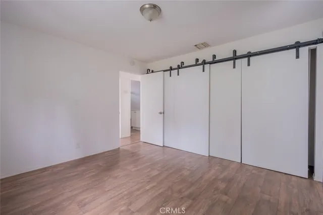 a view of a room with wooden floor