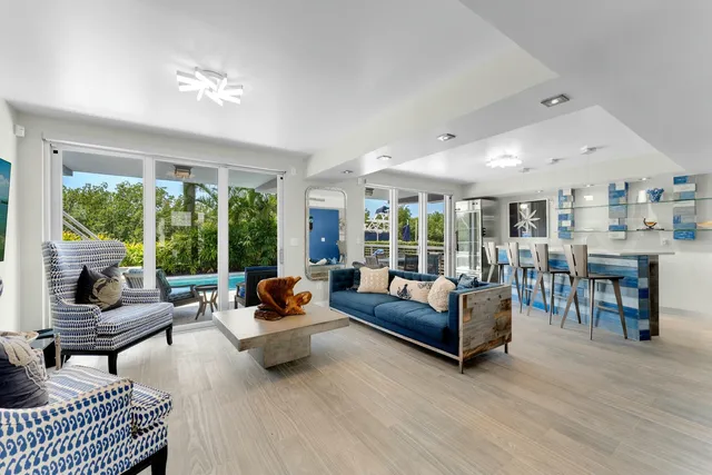 a dining room with furniture and a floor to ceiling window