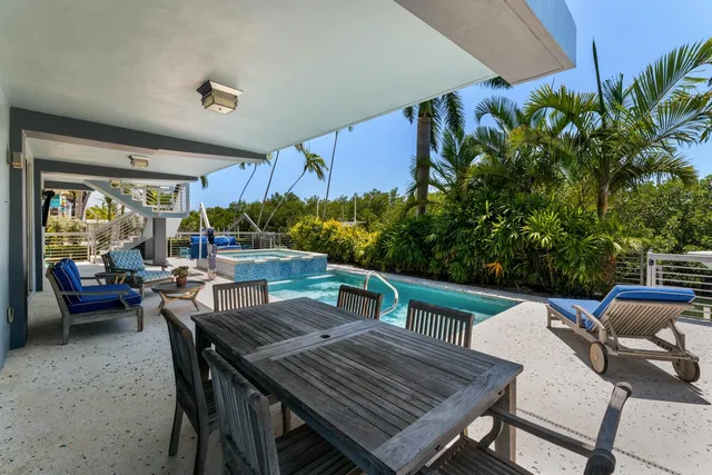 a dining room with furniture a chandelier and wooden floor