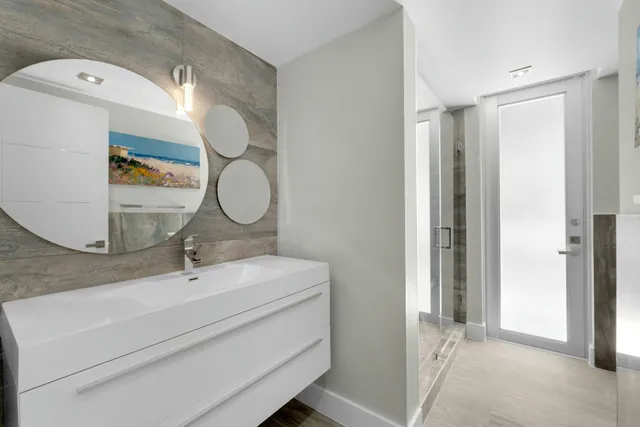 a dining room with wooden floor a chandelier a wooden table and chairs