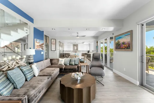 an aerial view of ocean and residential houses with outdoor space