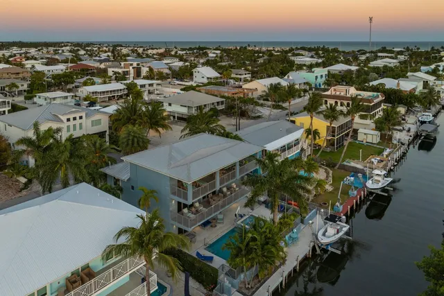 a view of a patio with table and chairs with wooden floor and fence