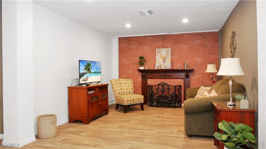 11751 Shawnee Road Fort Myers, FL 33913 - Photo 11 of 32 a living room with furniture and a fireplace