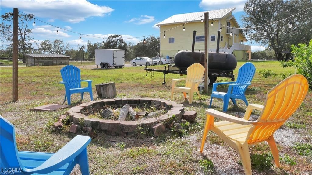 11751 Shawnee Road Fort Myers, FL 33913 - Photo 13 of 32 a view of a swimming pool with a patio and a yard