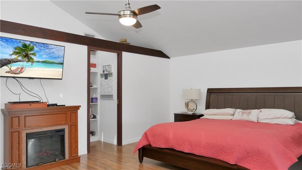 11751 Shawnee Road Fort Myers, FL 33913 - Photo 17 of 32 a bedroom with a bed and a fireplace
