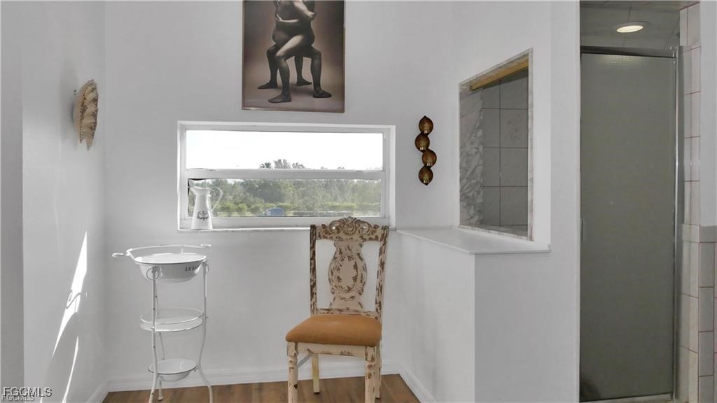 11751 Shawnee Road Fort Myers, FL 33913 - Photo 18 of 32 a view of hallway with chair and a window