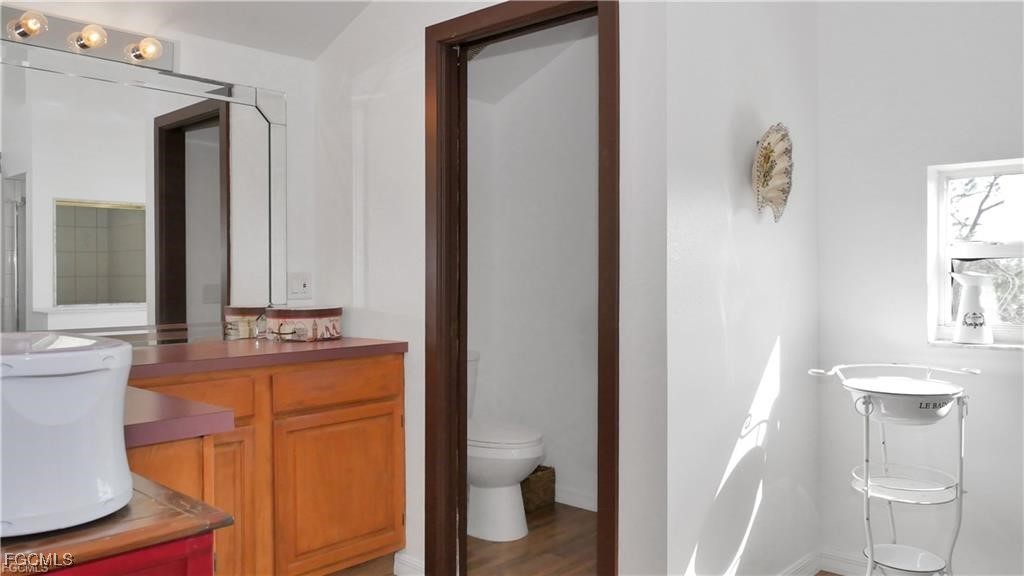 11751 Shawnee Road Fort Myers, FL 33913 - Photo 19 of 32 a bathroom with a granite countertop sink and a mirror