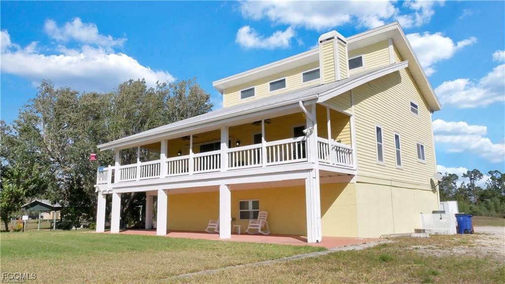 11751 Shawnee Road Fort Myers, FL 33913 - Photo 2 of 32 front view of a house with a yard