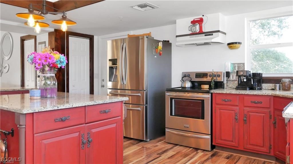 11751 Shawnee Road Fort Myers, FL 33913 - Photo 21 of 32 a kitchen with granite countertop a sink stainless steel appliances and cabinets