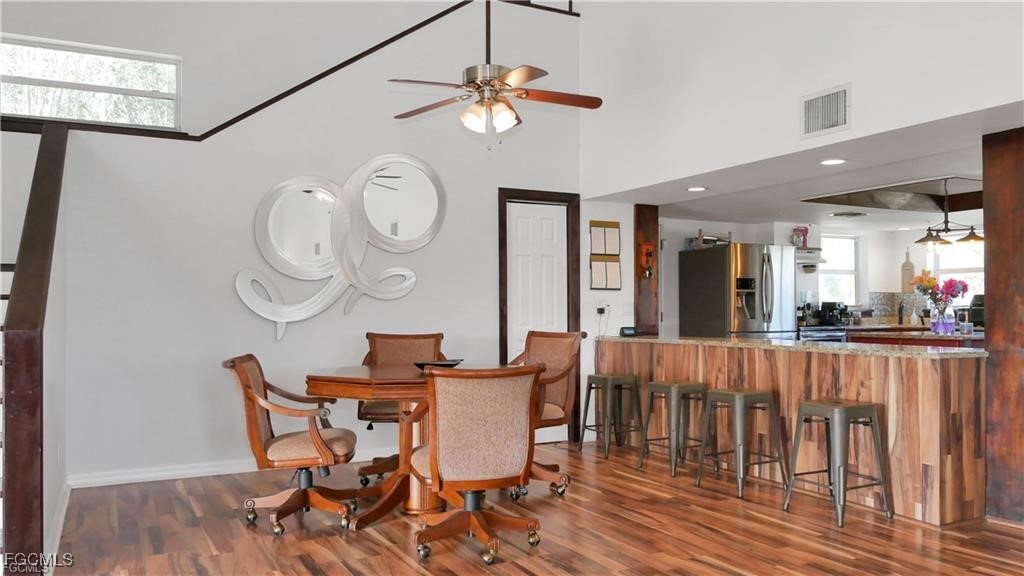 11751 Shawnee Road Fort Myers, FL 33913 - Photo 24 of 32 a view of a dining room and livingroom with furniture wooden floor a chandelier