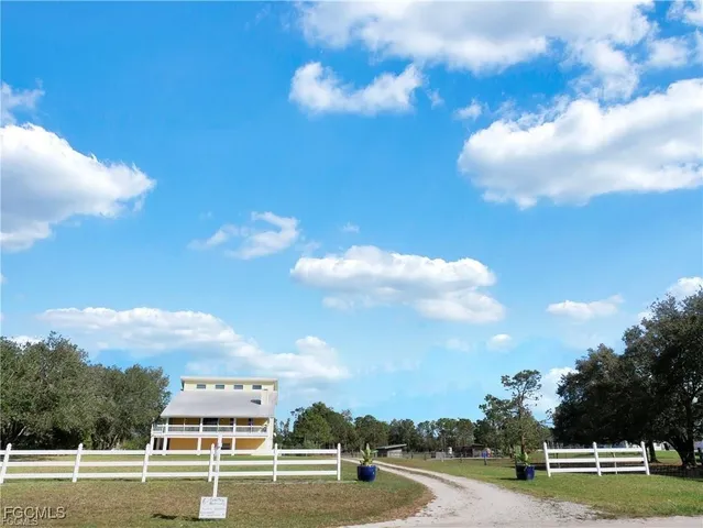 a view of a house with a yard and sitting area