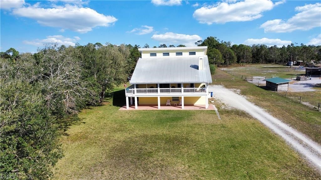 11751 Shawnee Road Fort Myers, FL 33913 - Photo 4 of 32 a view of a house with a yard and sitting area