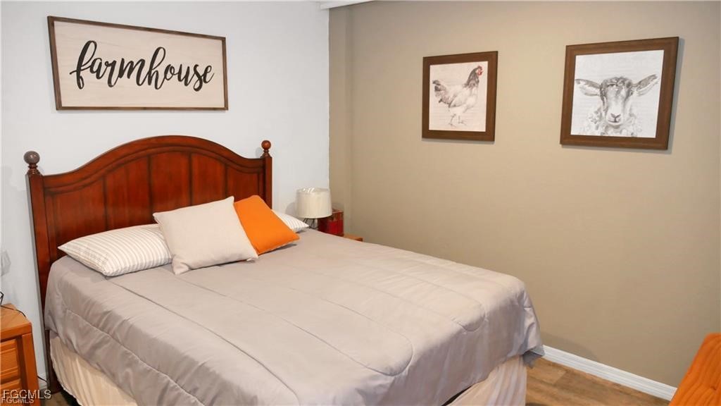 11751 Shawnee Road Fort Myers, FL 33913 - Photo 8 of 32 a bedroom with a bed and cupboard