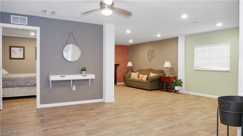 11751 Shawnee Road Fort Myers, FL 33913 - Photo 9 of 32 a living room with furniture and a wooden floor