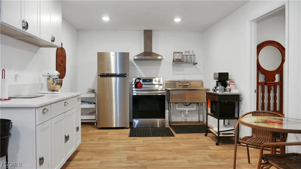 11751 Shawnee Road Fort Myers, FL 33913 - Photo 10 of 32 a kitchen with stainless steel appliances granite countertop a refrigerator and a stove top oven