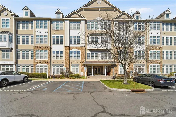 a view of a white house with a swimming pool and lawn chairs