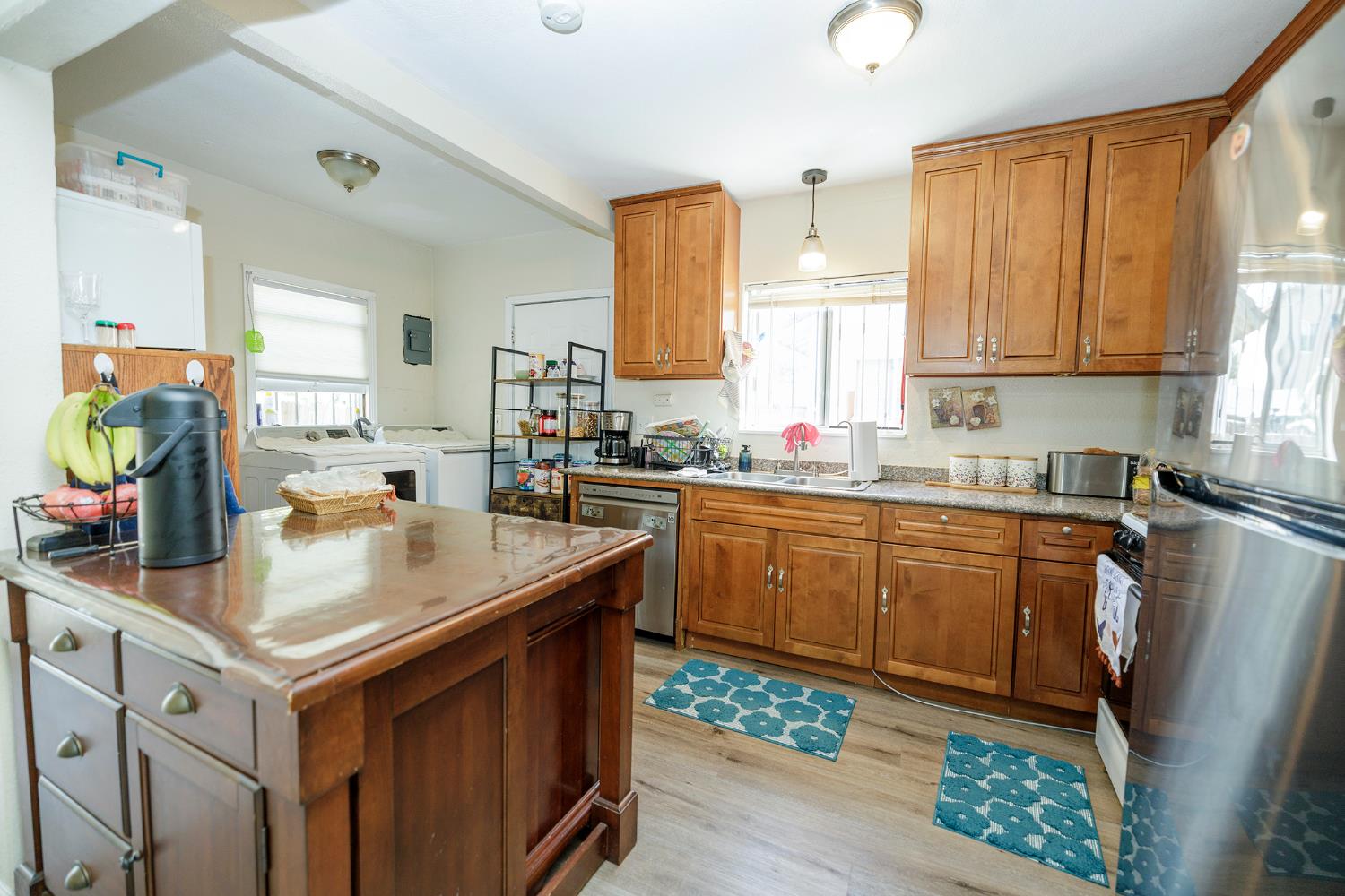 421 East 8th Street Stockton, CA 95206 - Photo 11 of 20 a kitchen with stainless steel appliances granite countertop a sink stove and refrigerator