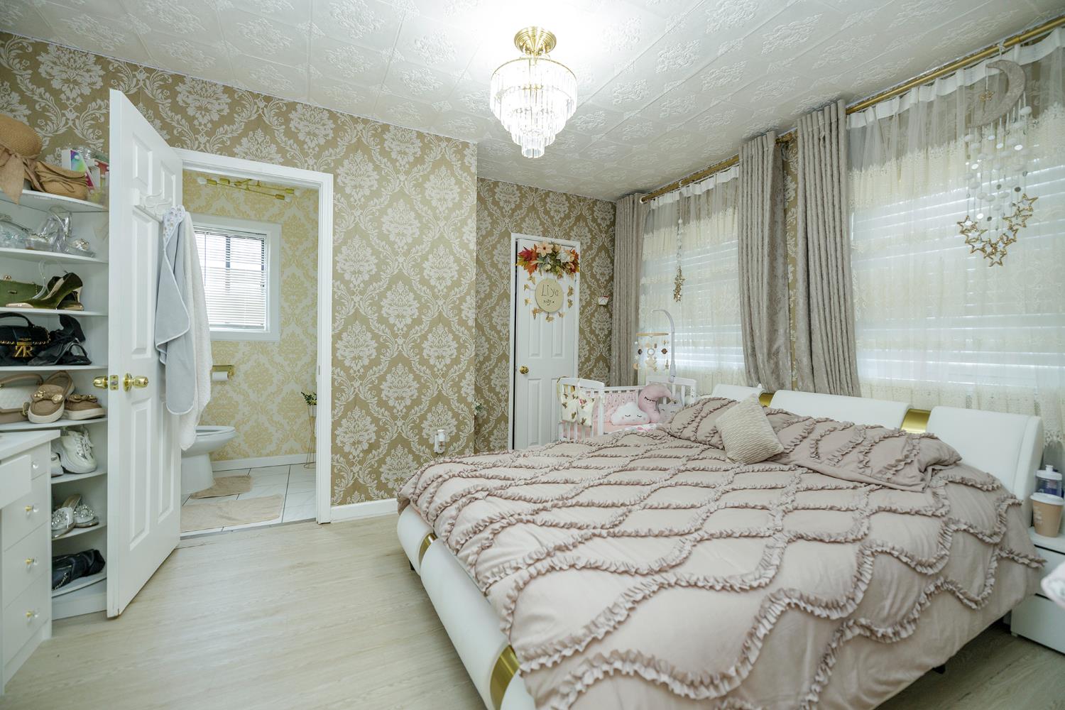 421 East 8th Street Stockton, CA 95206 - Photo 13 of 20 a bedroom with a bed and a chandelier