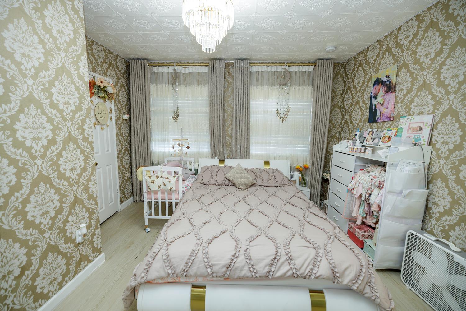 421 East 8th Street Stockton, CA 95206 - Photo 14 of 20 a large bedroom with a bed and a chair